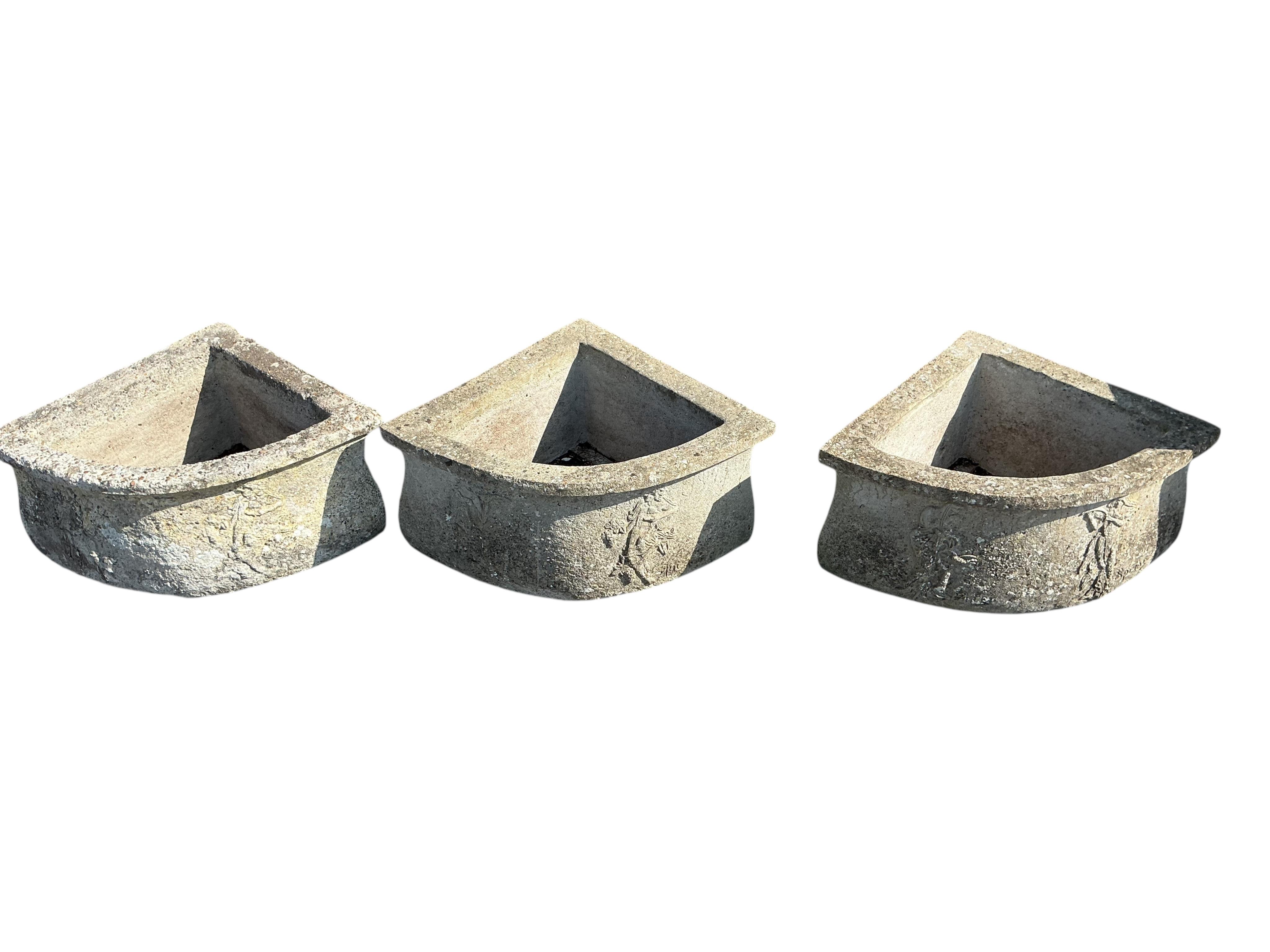 A set of three triangular reconstituted stone garden planters, width 60cm, depth 45cm, height 25cm
